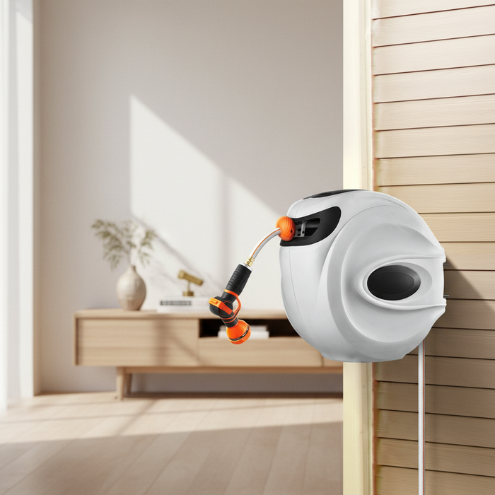 Nestora hose reel on a tidy patio wall beside a bed of summer blooms